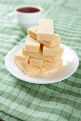 Wafer biscuits served with tea.