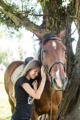 Foto op Canvas Portrait girl and horse in outdoor. Girl hugging a horse © Nestyda