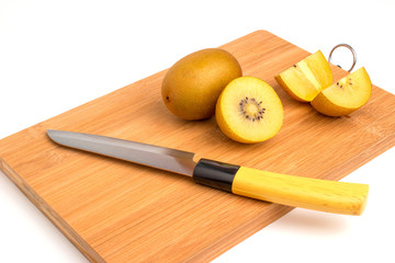 gold kiwi wish knife on Chopping board.