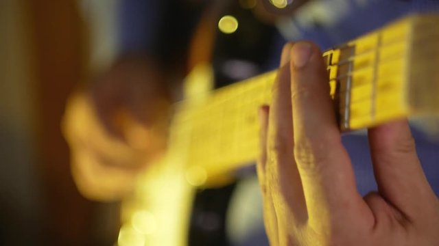 Musician plays blues by electric guitar at the record studio close-up