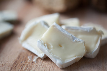 cheese brie lying on a wooden platter