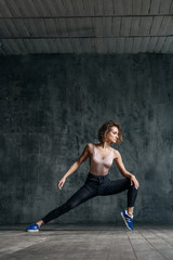 Fototapeta premium Young beautiful dancer is posing in studio