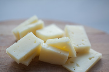 cheese cheddar lying on a wooden platter