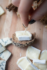 hands holding Snacks of bread and brie cheese