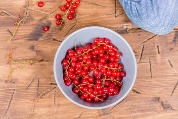 red currants on a wooden background