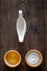 Put the dough. Flour, oil, milk on dark wooden table background top view copyspace