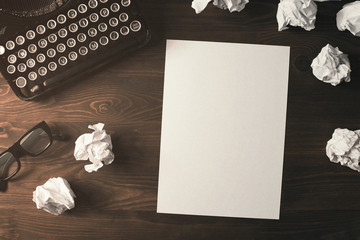High angle view of blank paper sheet on a wooden desk with copy space