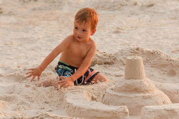 Child and sand castle.