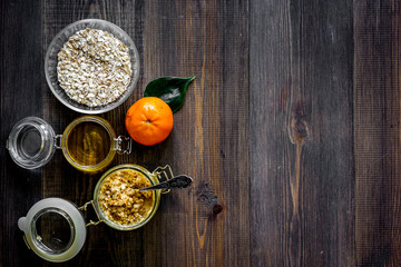 Sweet summer breakfast. Oatmeal, oranges, honey, sugar on wooden table background top view copyspace