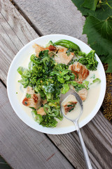 Nutritious dish of roasted pork fillet, green pepper, greens, broccoli in cream