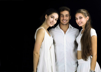 beautiful two girls and one boy dressed in white smiling