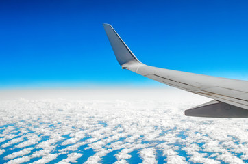 Obraz premium Beautiful classic view of the porthole during a flight by plane, clouds of blue sky and earth