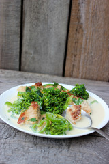 Nutritious dish of roasted pork fillet, green pepper, greens, broccoli in cream