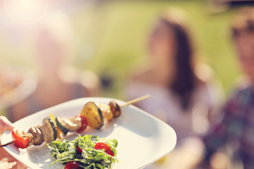 Friends having barbecue party in backyard
