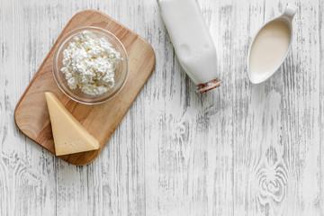 Natural food. Milk, cottage, cheese on light wooden background top view copyspace