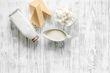 Farm dairy products. Milk, cottage, cheese on light wooden background top view copyspace