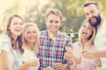 Group of friends having fun with sparklers
