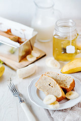 Sweets, desserts and pastries, banana bread or pcake with fresh fruits, milk and green tea on a light background