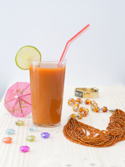 A glass of carrot juice on a wooden table. 