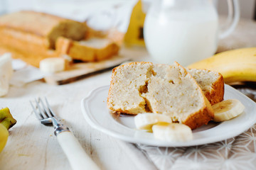 Sweets, desserts and pastries, banana bread or pcake with fresh fruits, milk and green tea on a light background