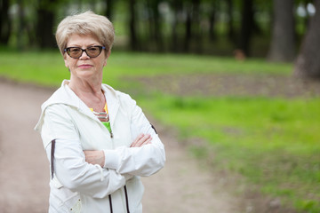 Portrait of senior coach and trainer woman standing with crossed arms at training, copyspace