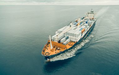 Aerial view of cargo ship sailing in open sea
