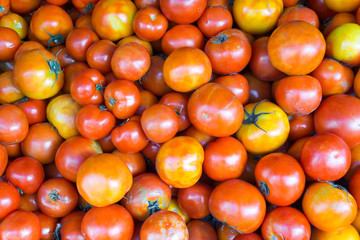 Fototapeta na wymiar Close-up red tomatoes background. Group of tomatoes at market