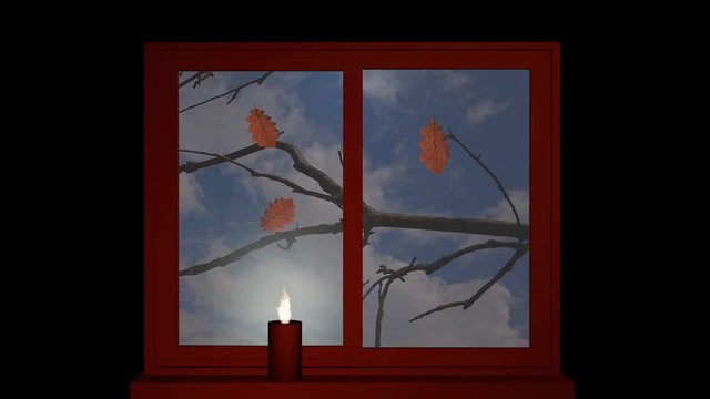 herbstliches Fenster mit flackernder Kerze auf der Fensterbank