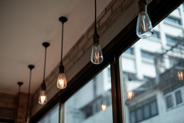 Electric light bulbs turned on with vintage house background. Concept of idea, imagination, innovation, creativity for business use.