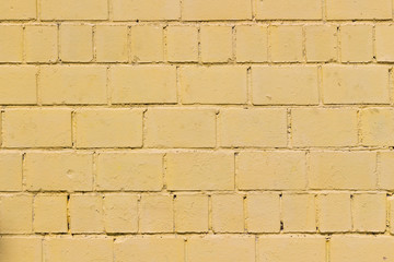 Wall of painted yellow brick