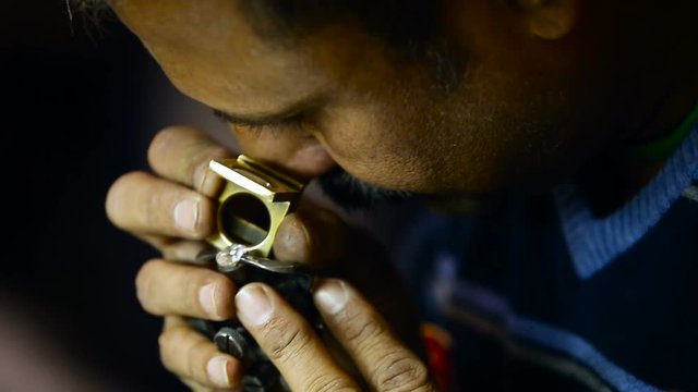 Jewellry Industry. Man Working on Dimond. Worker Holding Crystal With Force Clamp, Watching Through Magnifying Glass