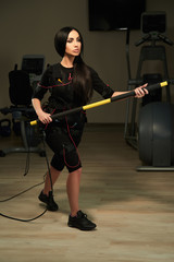 EMS fitness woman with a bar on flexible band