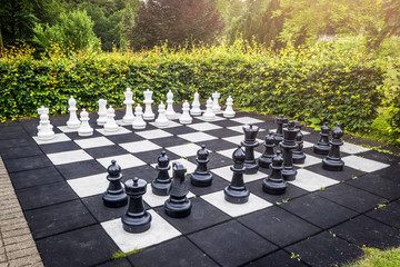 Large outdoor chess game on a garden terrace