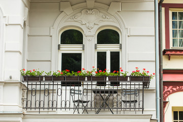 Fototapeta na wymiar balcony with flower pots and chairs