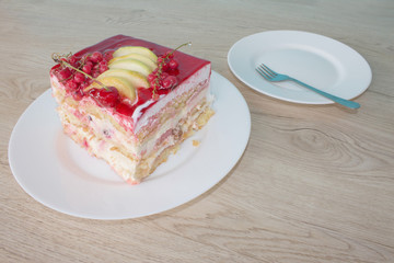 A piece cake on dish with currant in a relaxing time. Cake with red currant