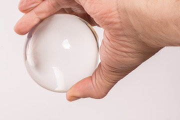 Fototapeta na wymiar Glass globe held in a man's hand against a white background