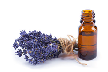 Lavender oil and flowers isolated on white background