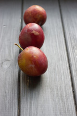 fresh plums on wooden table