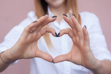 girl holding hands in heart shape