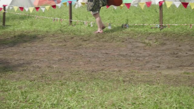 Man with guitar goes straight to tent camp