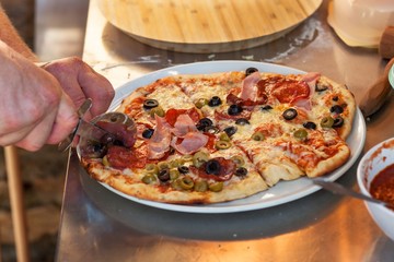 Domestic production of pizza. Preparing food for guests. Pizza party.