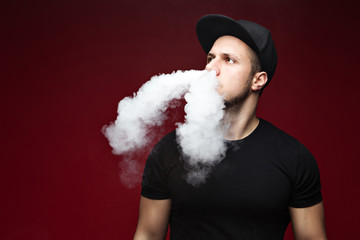 Vaping man and a cloud of vapor