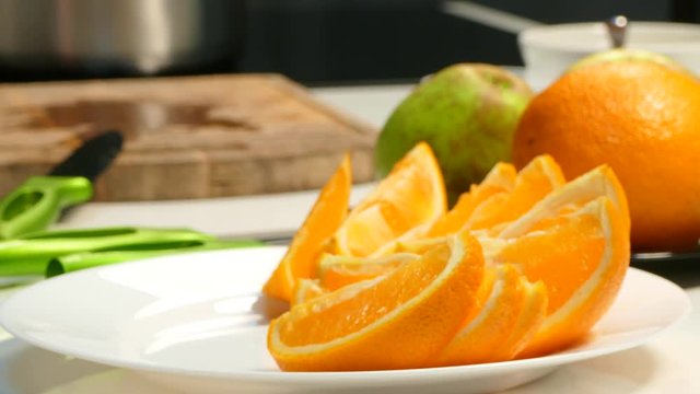 Laying Out Slices Of Orange On A Plate