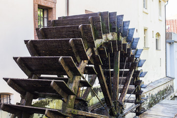 Working watermill wheel with falling water in the village © satura_