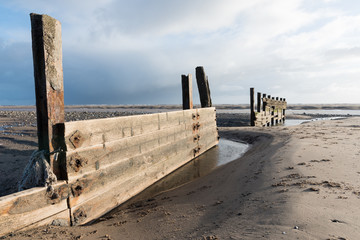 cleveleys, england, 02/17/2016, A rustic, weathered wooden sea defence wall, showing signs of damage...