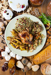 Unique beautiful christmas meal platter, with roast chicken and vegetables, surrounded by cakes, mince pies, fruit, bread and jam.