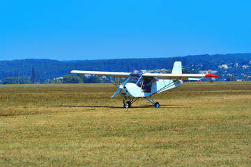 Fototapeta na wymiar A small white plane landed on the airfield