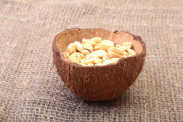 Roasted peeled peanuts in Handmade bowl of coconut, Selective Focus