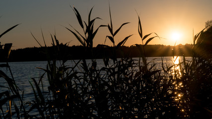 beautiful sunset on the lake, fishermen on the boat.