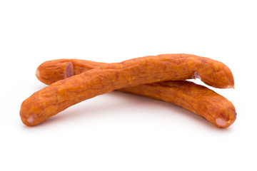 Stack of smoked sausages isolated on a white background.